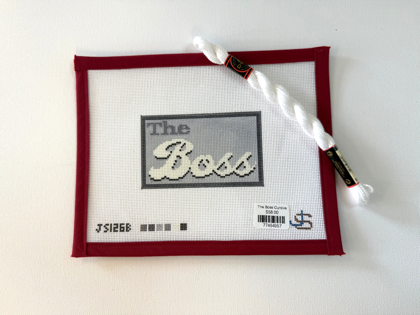 Cross-stitched piece with 'The Boss' text on a white background