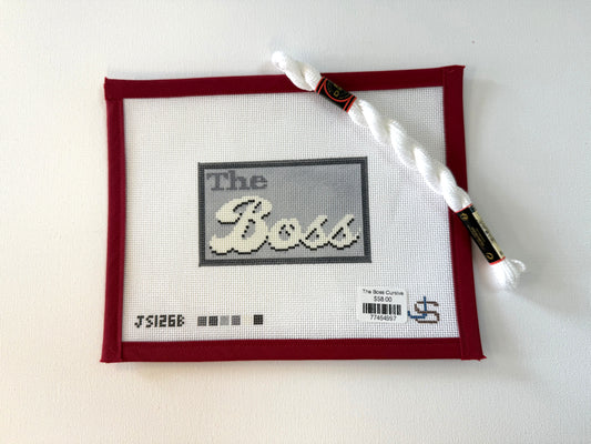 Cross-stitched piece with 'The Boss' text on a white background